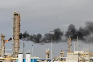 Flames shoot out of a chimney at Alexandria National Refining and Petrochemicals Company (ANRPC)