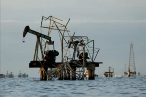 Abandoned pumpjacks damaged over time at a field of state oil company PDVSA on Lake Maracaibo