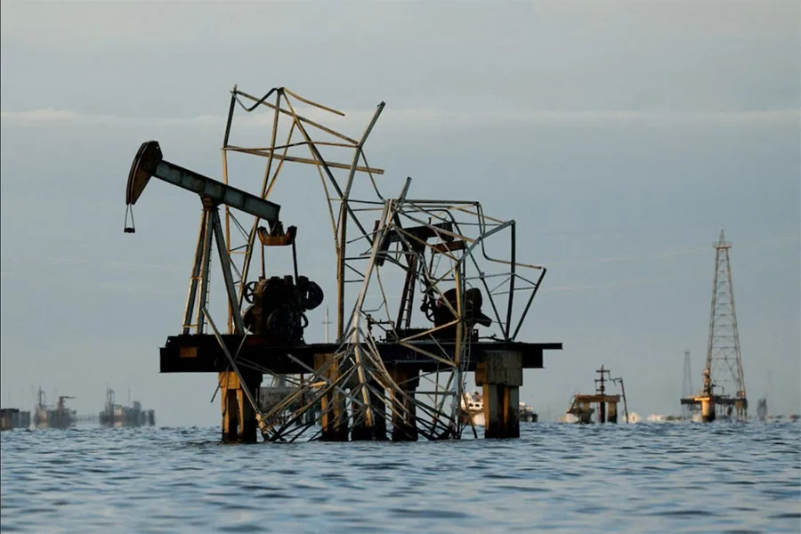 Abandoned pumpjacks damaged over time at a field of state oil company PDVSA on Lake Maracaibo